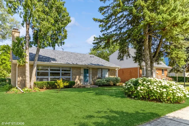a front view of a house with a garden and plants
