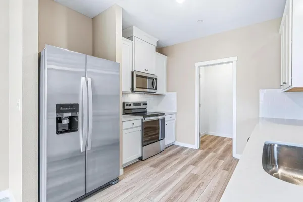 a kitchen with a refrigerator stove and microwave