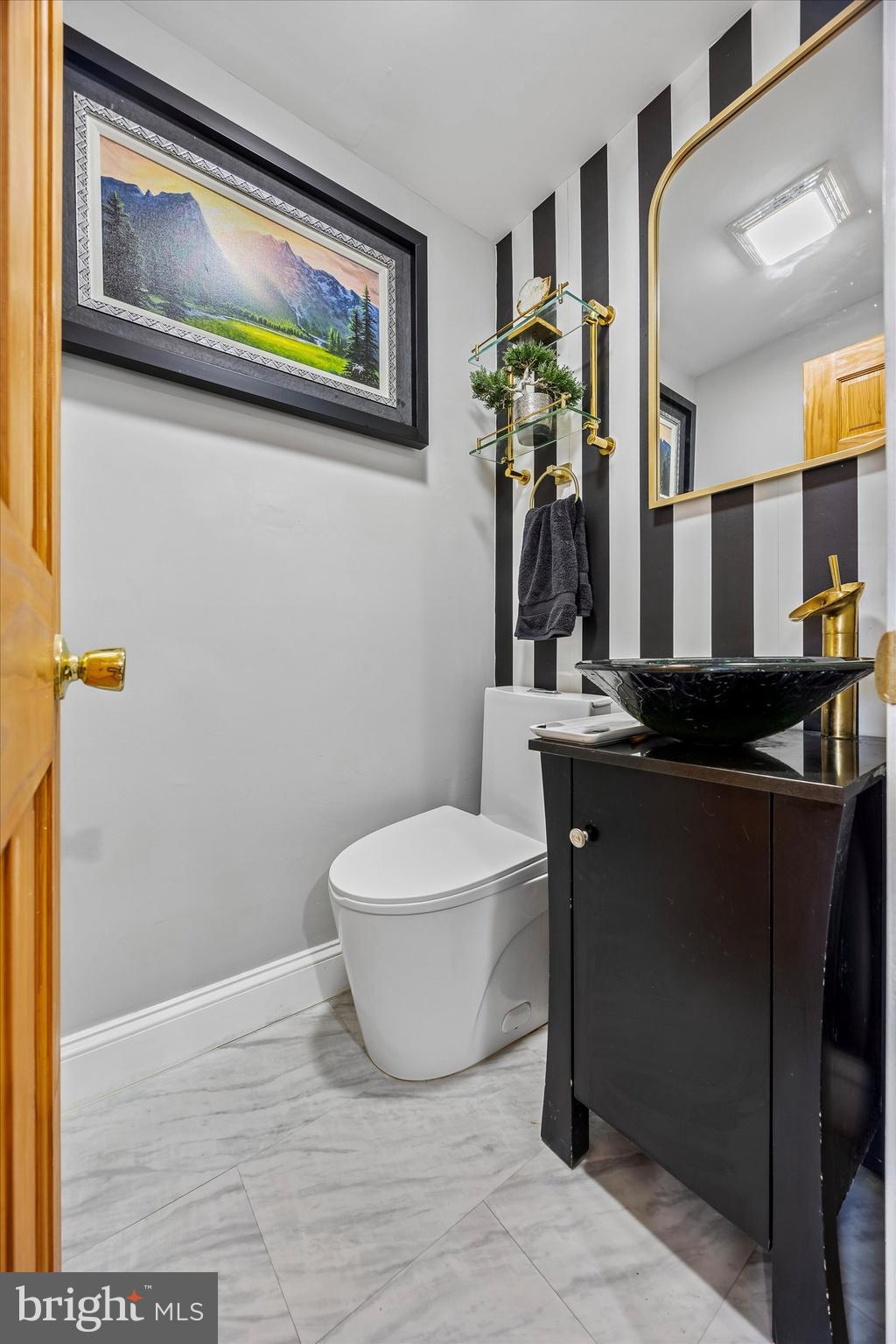 145 Conarroe Street Philadelphia, PA 19127 - Photo 12 of 28 a bathroom with a toilet a sink and mirror