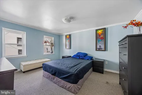 a bedroom with furniture and window