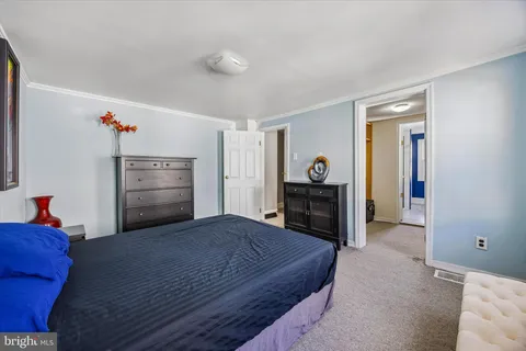 a living room with furniture and a dresser