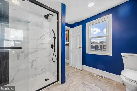 a bathroom with a shower toilet and sink
