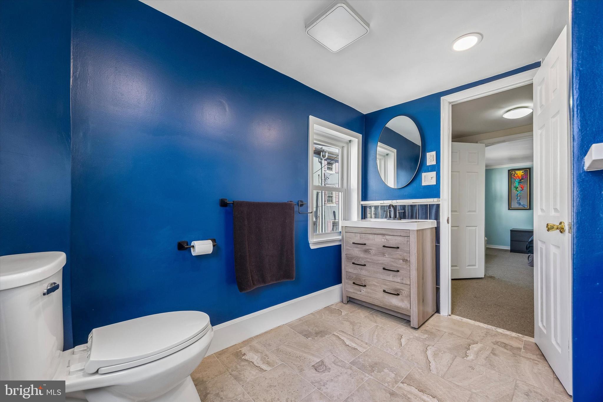 145 Conarroe Street Philadelphia, PA 19127 - Photo 19 of 28 a bathroom with a toilet a sink and mirror