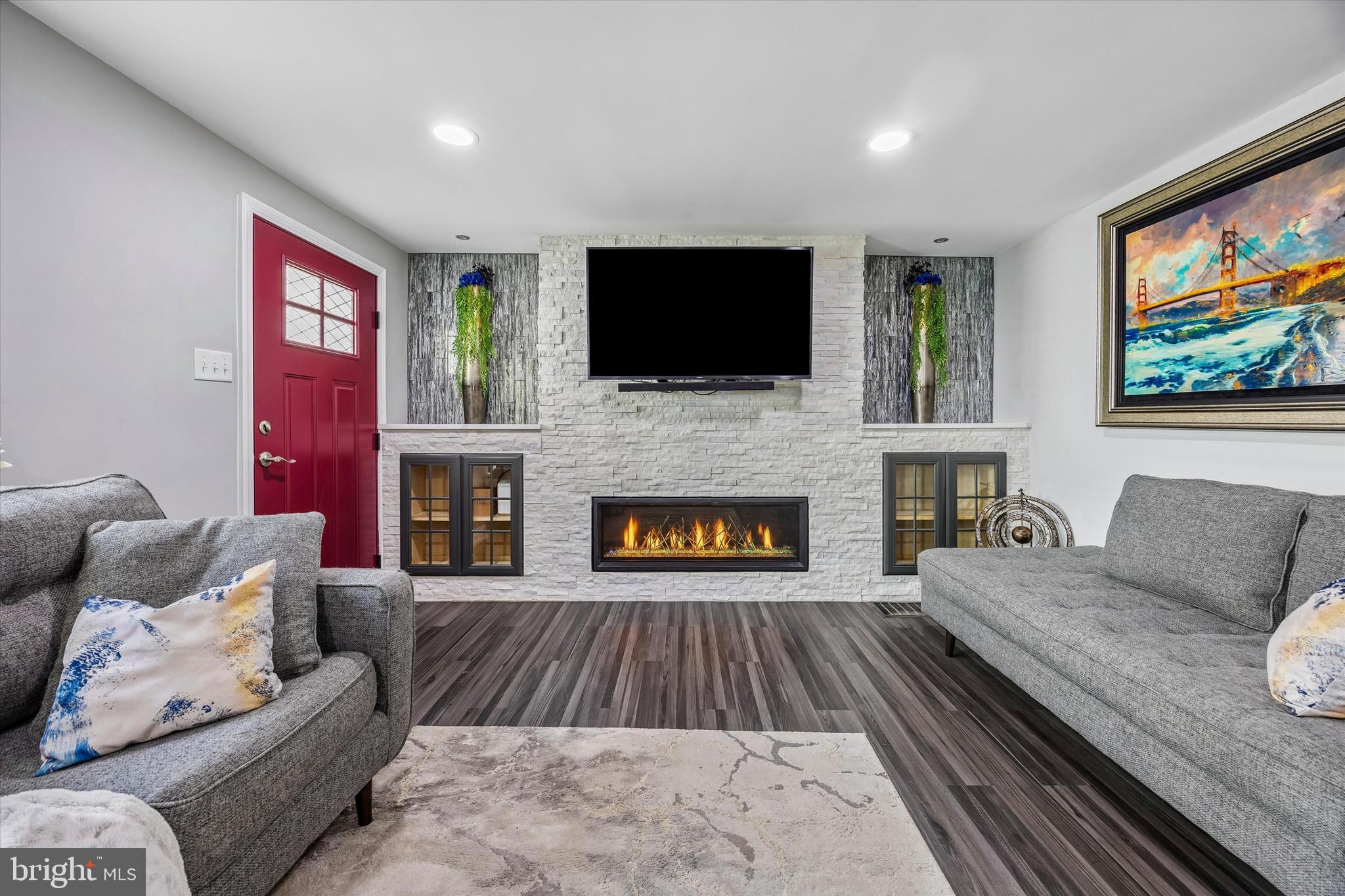 145 Conarroe Street Philadelphia, PA 19127 - Photo 2 of 28 a living room with furniture a flat screen tv and a fireplace