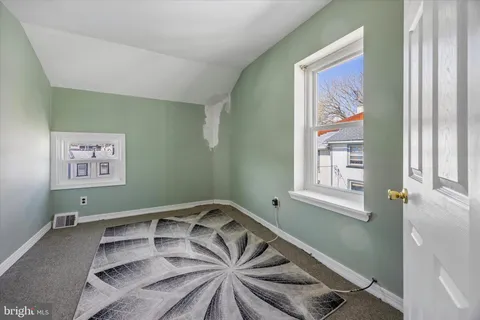 a view of a room with window and furniture