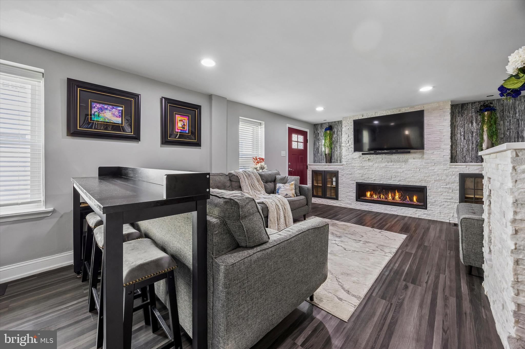 145 Conarroe Street Philadelphia, PA 19127 - Photo 3 of 28 a living room with furniture a flat screen tv and a fireplace