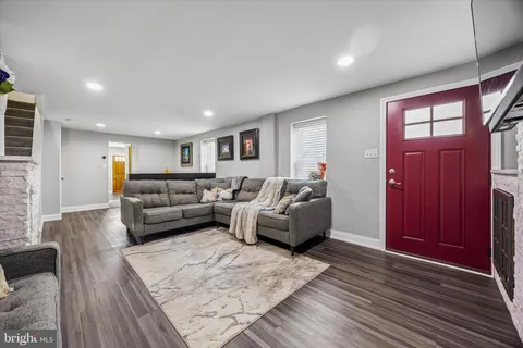 a living room with furniture window and wooden floor