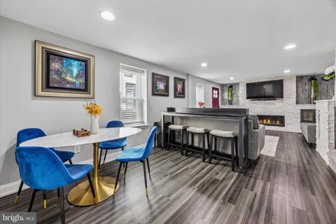a view of a dining room with furniture a rug and wooden floor