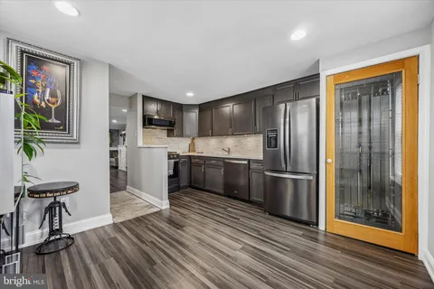 a kitchen with stainless steel appliances a refrigerator and a stove top oven