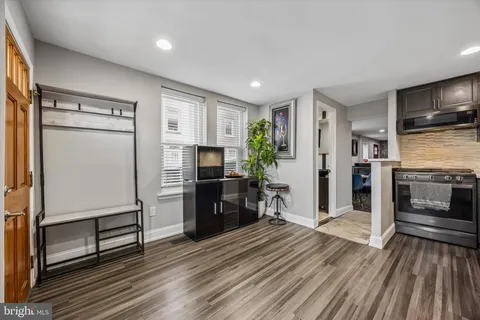 a kitchen with a refrigerator and a stove top oven