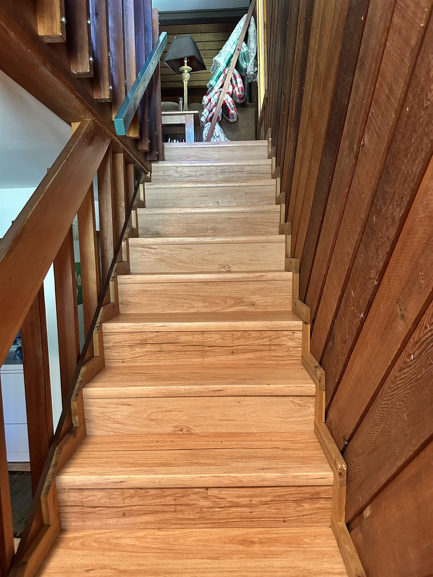 315 Fascination, Unit 315 Mammoth Lakes, CA 93546 - Photo 21 of 44 Wood-finish staircase featuring a wood-panel accent wall and wood railings
