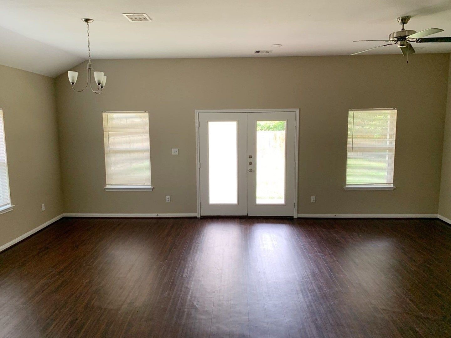 8205 Claiborne Street Houston, TX 77078 - Photo 13 of 26 a view of an empty room with wooden floor and a window