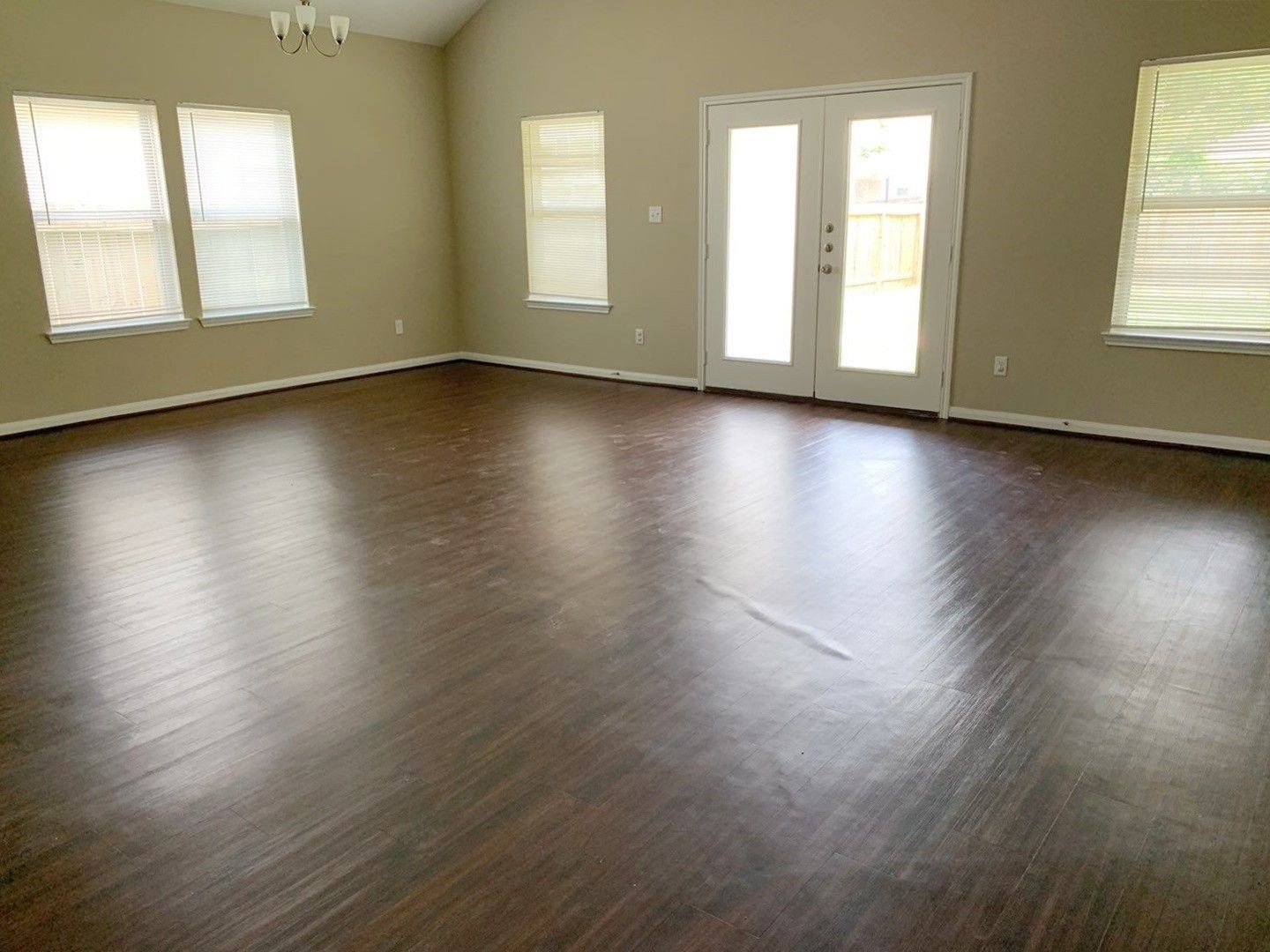 8205 Claiborne Street Houston, TX 77078 - Photo 14 of 26 an empty room with wooden floor and windows