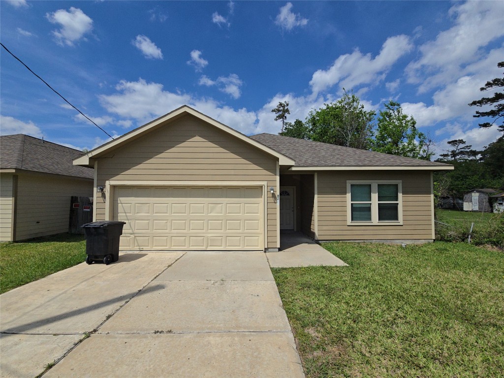 8205 Claiborne Street Houston, TX 77078 - Photo 2 of 26 a front view of house with yard and trees in the background