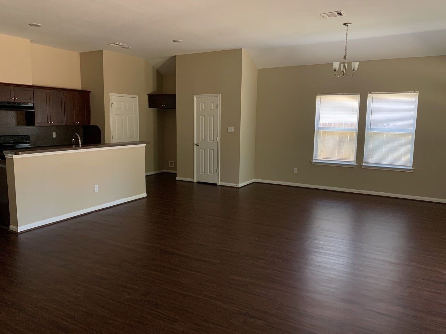 8205 Claiborne Street Houston, TX 77078 - Photo 4 of 26 an empty room with wooden floor and windows