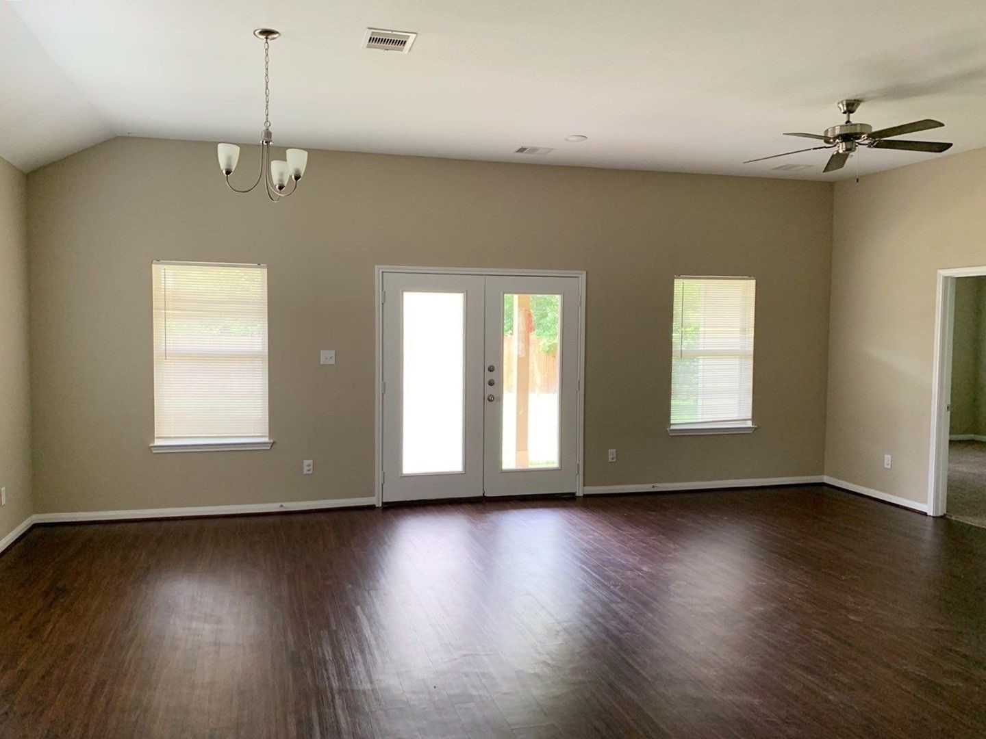 8205 Claiborne Street Houston, TX 77078 - Photo 9 of 26 a view of an empty room with wooden floor and a window