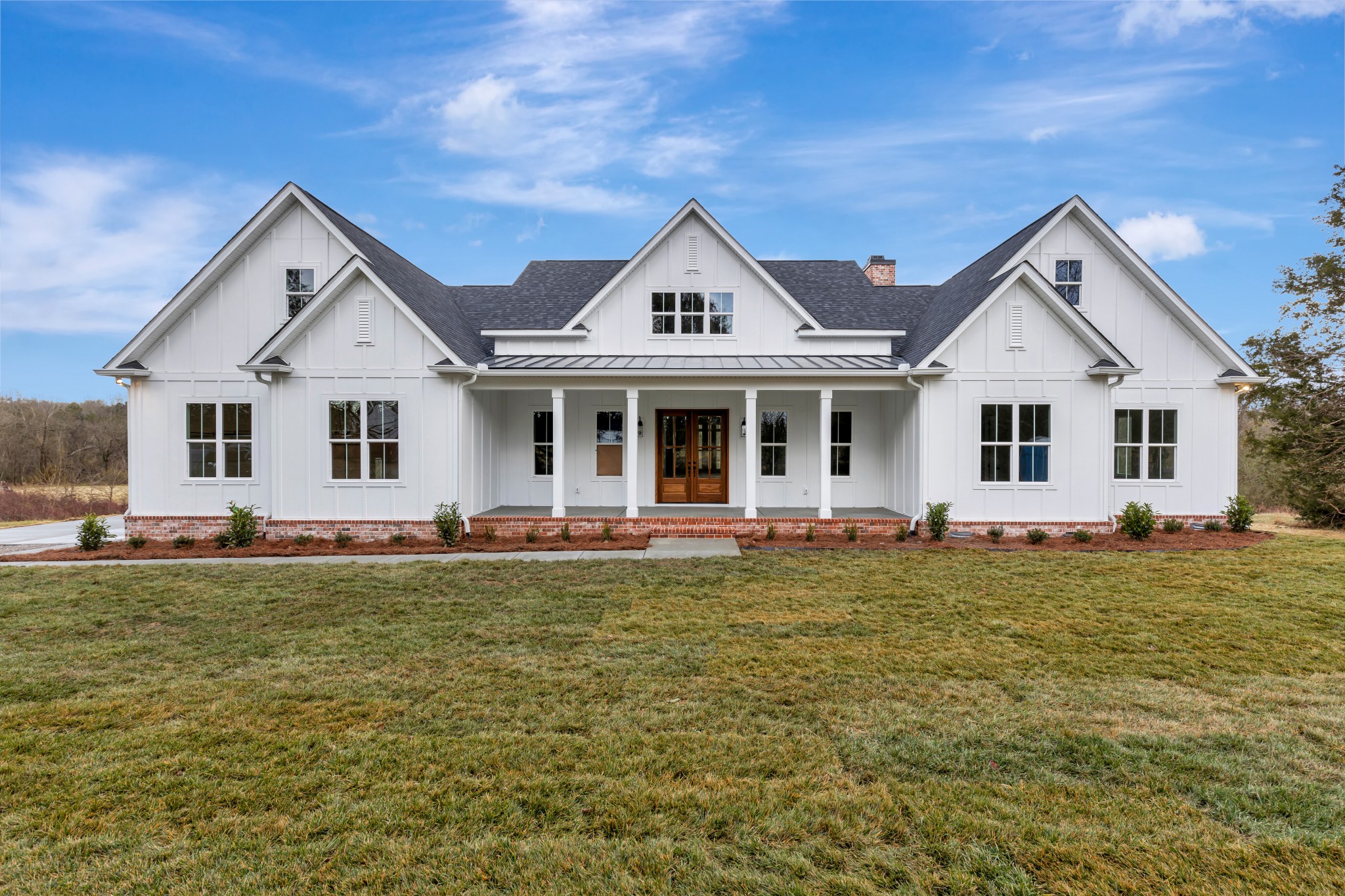 a front view of a house with a garden