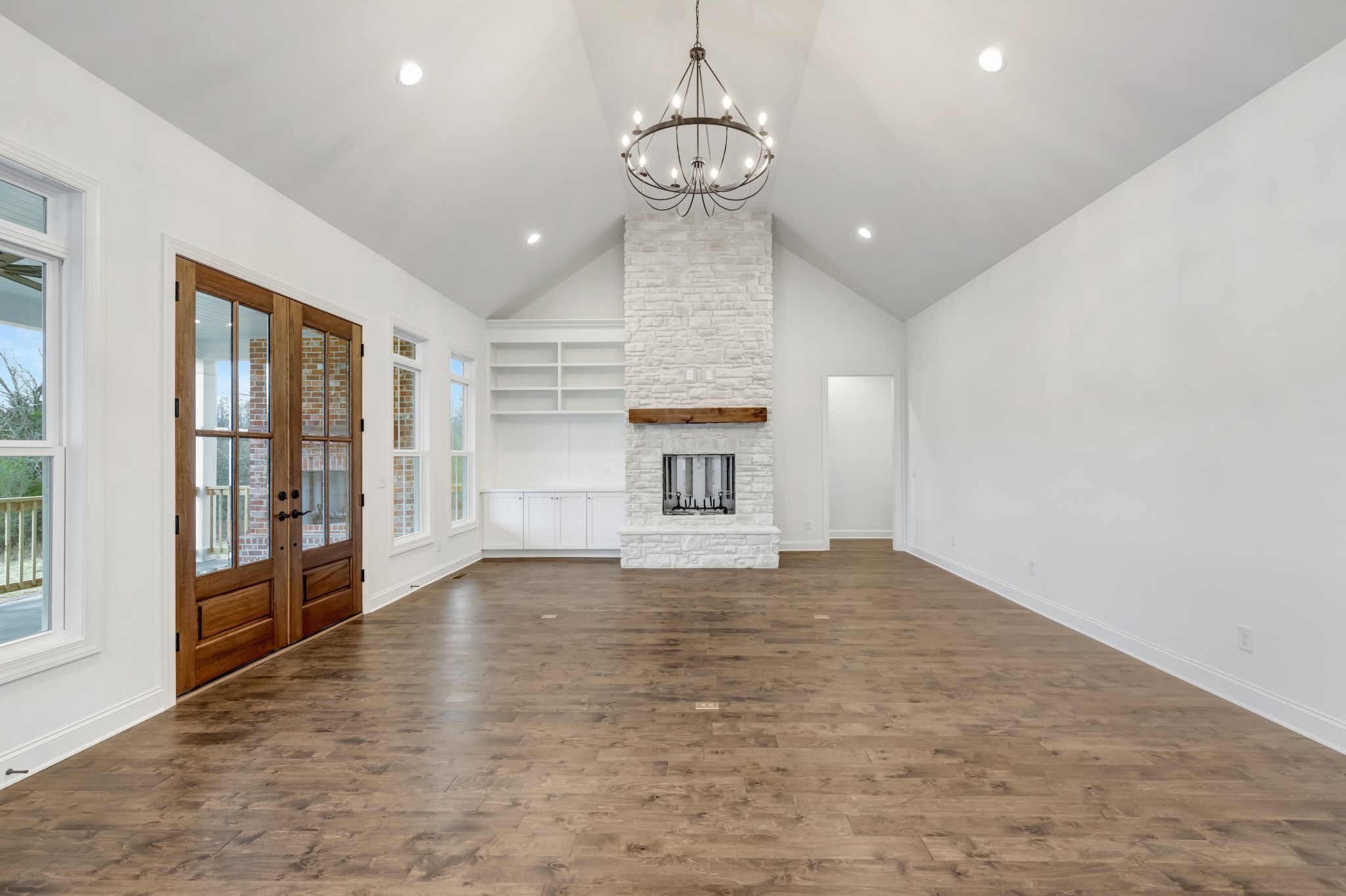 7483 Liberty Road Fairview, TN 37062 - Photo 14 of 65 a view of empty room with wooden floor and fireplace