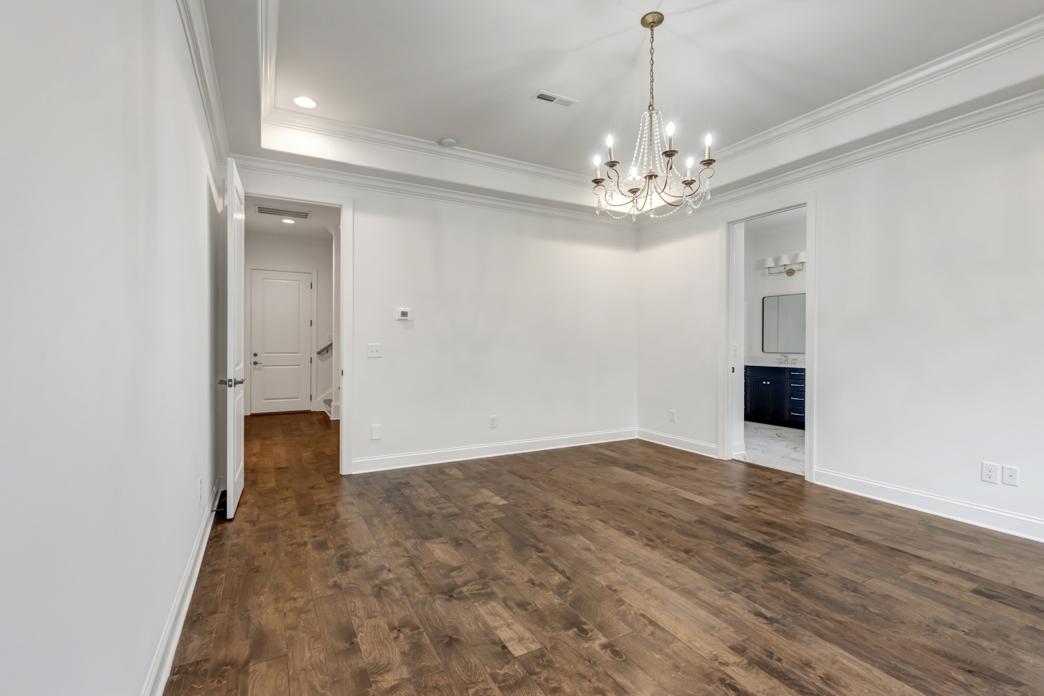 7483 Liberty Road Fairview, TN 37062 - Photo 45 of 65 wooden floor in an empty room with a chandelier
