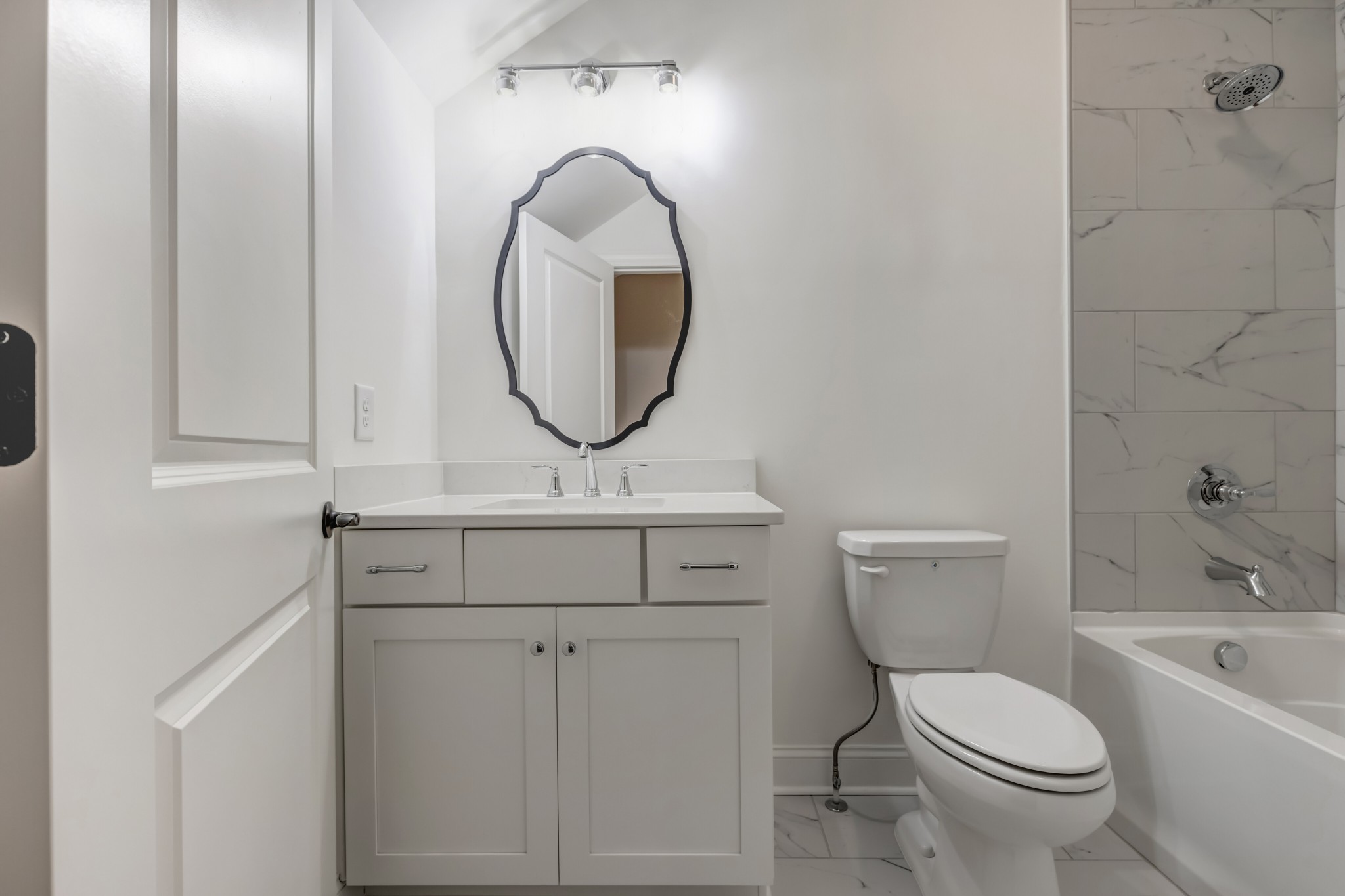 7483 Liberty Road Fairview, TN 37062 - Photo 46 of 65 a bathroom with a toilet a sink and a mirror