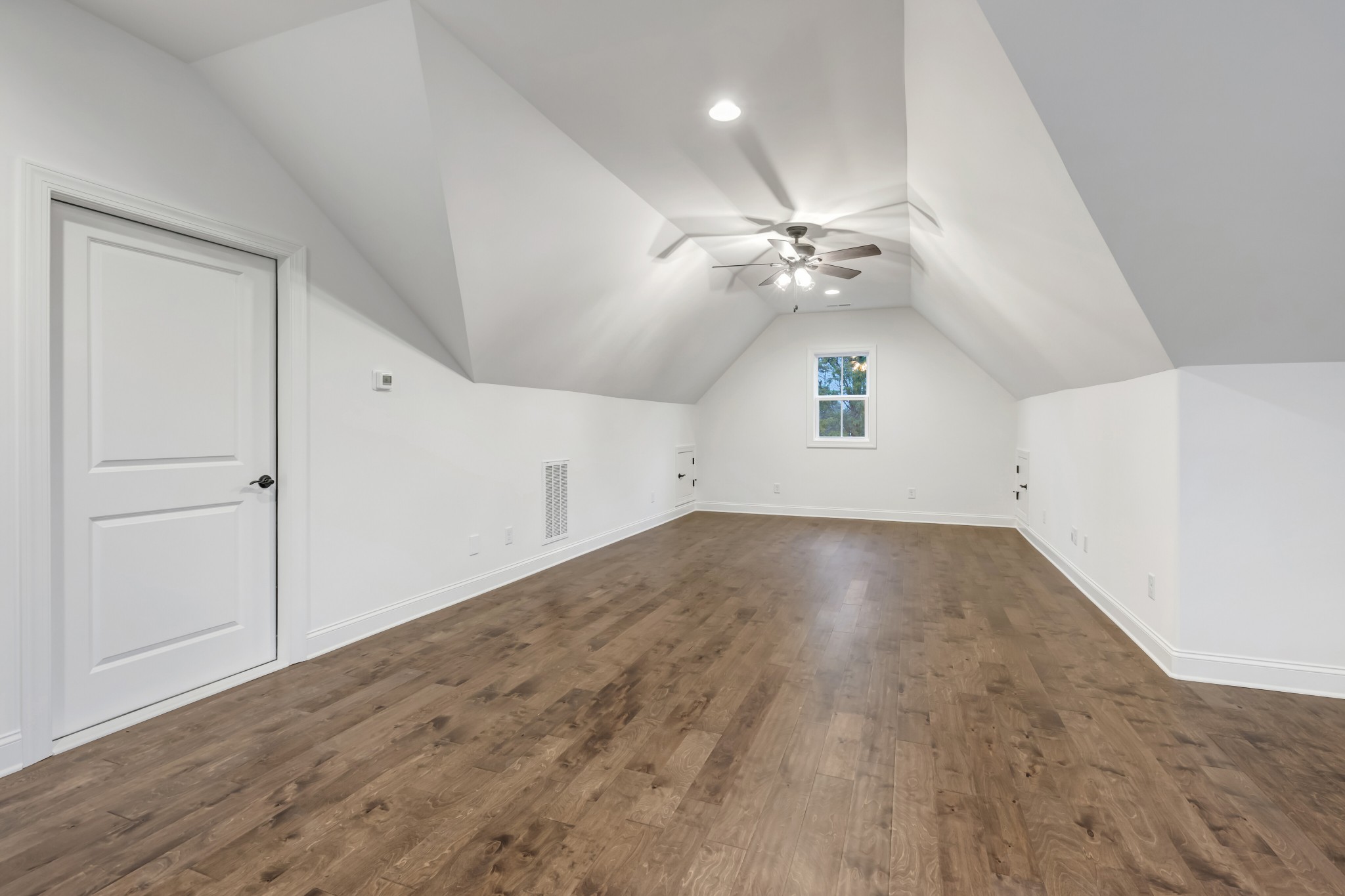 7483 Liberty Road Fairview, TN 37062 - Photo 48 of 65 an empty room with wooden floor ceiling fan and windows