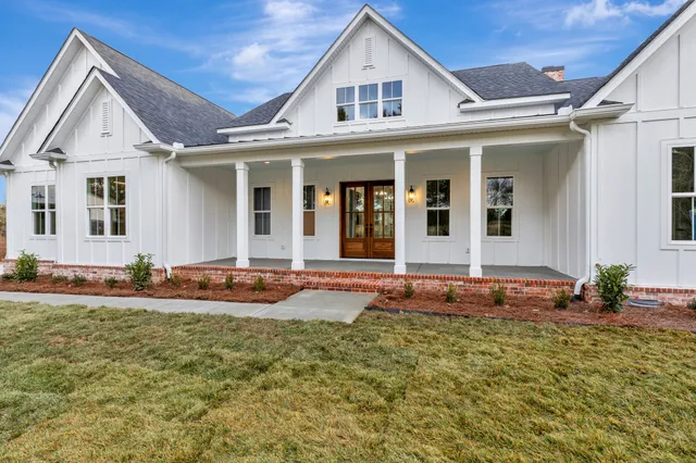 a view of a hallway with wooden floor and chandelier