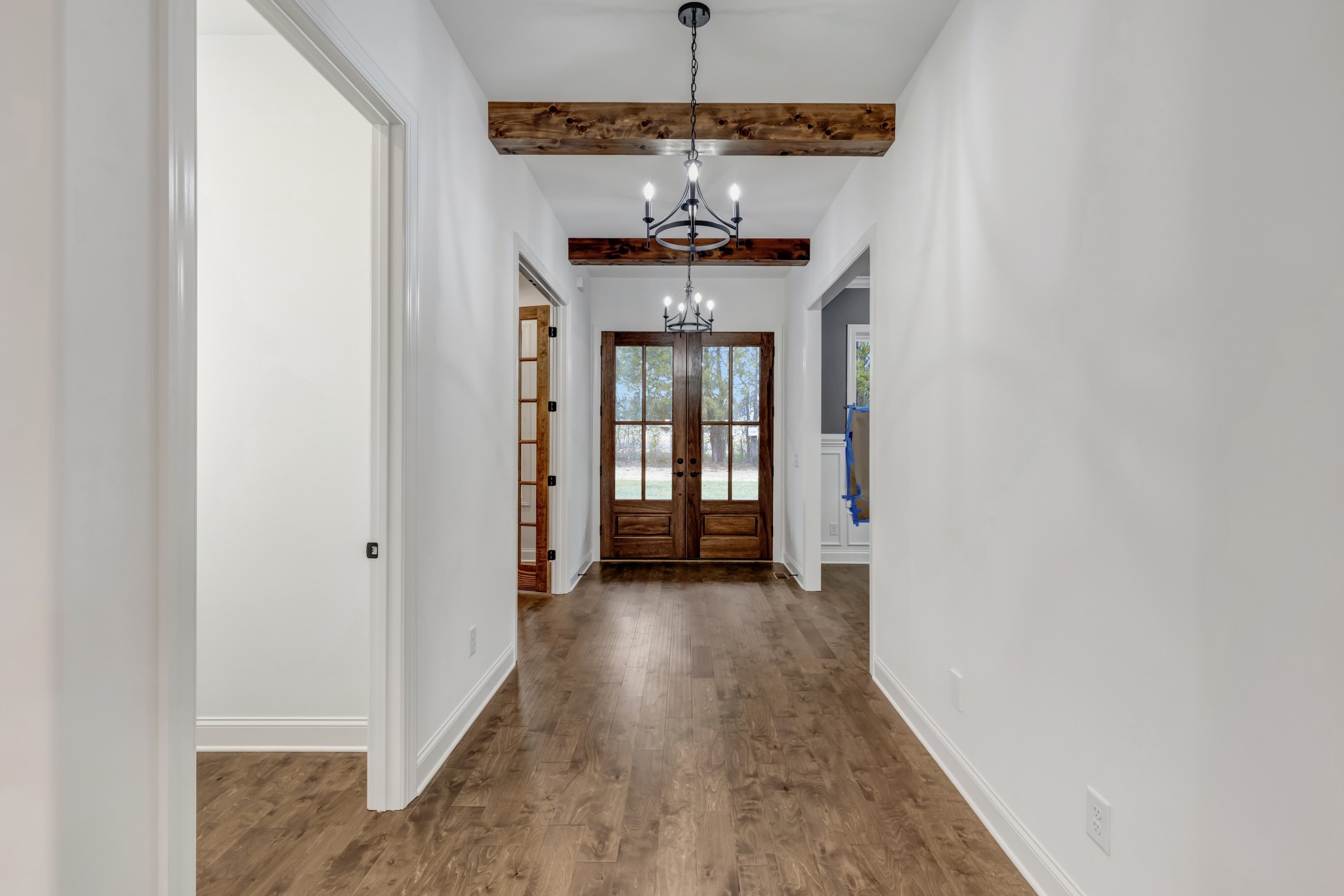 7483 Liberty Road Fairview, TN 37062 - Photo 7 of 65 a view of a hallway with wooden floor and chandelier