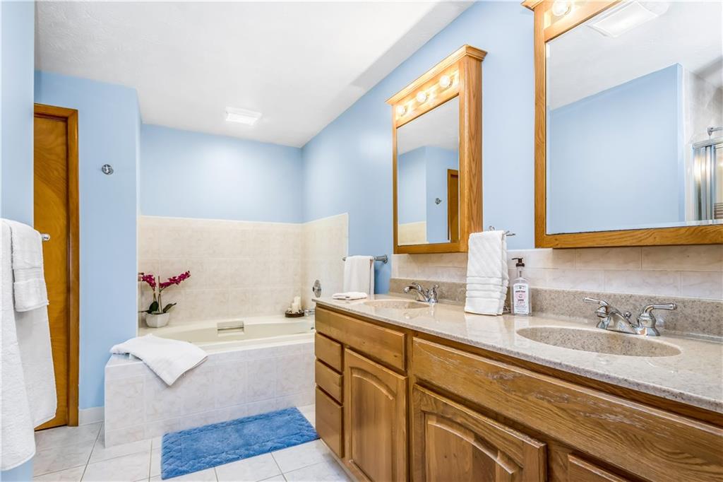 129 MacArthur Road Clairton, PA 15025 - Photo 14 of 25 Large Main Bathroom Features a Jet Spray Tub, Separate Shower and Vanity with Corian Counter Top and Double Sinks!