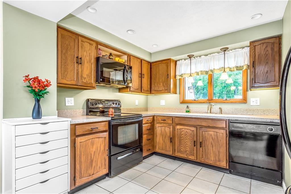 129 MacArthur Road Clairton, PA 15025 - Photo 7 of 25 Awesome and Updated Kitchen with Stainless Steel Appliances and Corian Counter Tops is Open to the Dining Room or Head Right Out to the Covered Rear Patio and Peaceful Backyard!