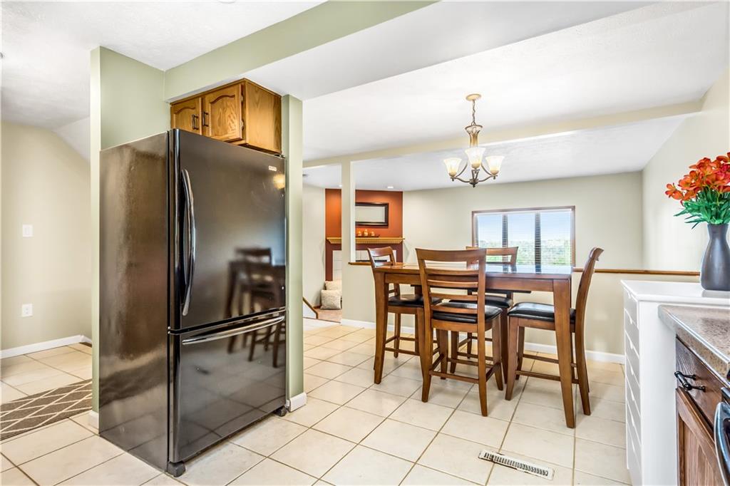 129 MacArthur Road Clairton, PA 15025 - Photo 8 of 25 Awesome and Updated Kitchen with Stainless Steel Appliances and Corian Counter Tops is Open to the Dining Room or Head Right Out to the Covered Rear Patio and Peaceful Backyard!