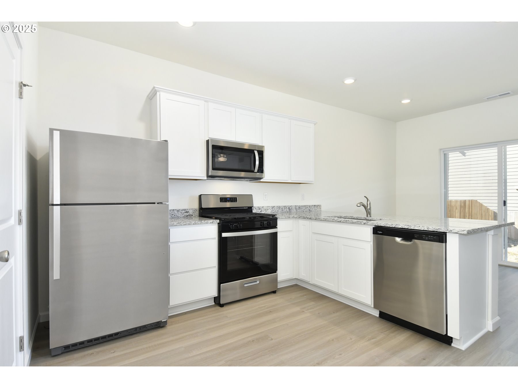 3933 Southwest Duniway Lane Gresham, OR 97080 - Photo 12 of 24 a kitchen with stainless steel appliances a refrigerator stove and microwave