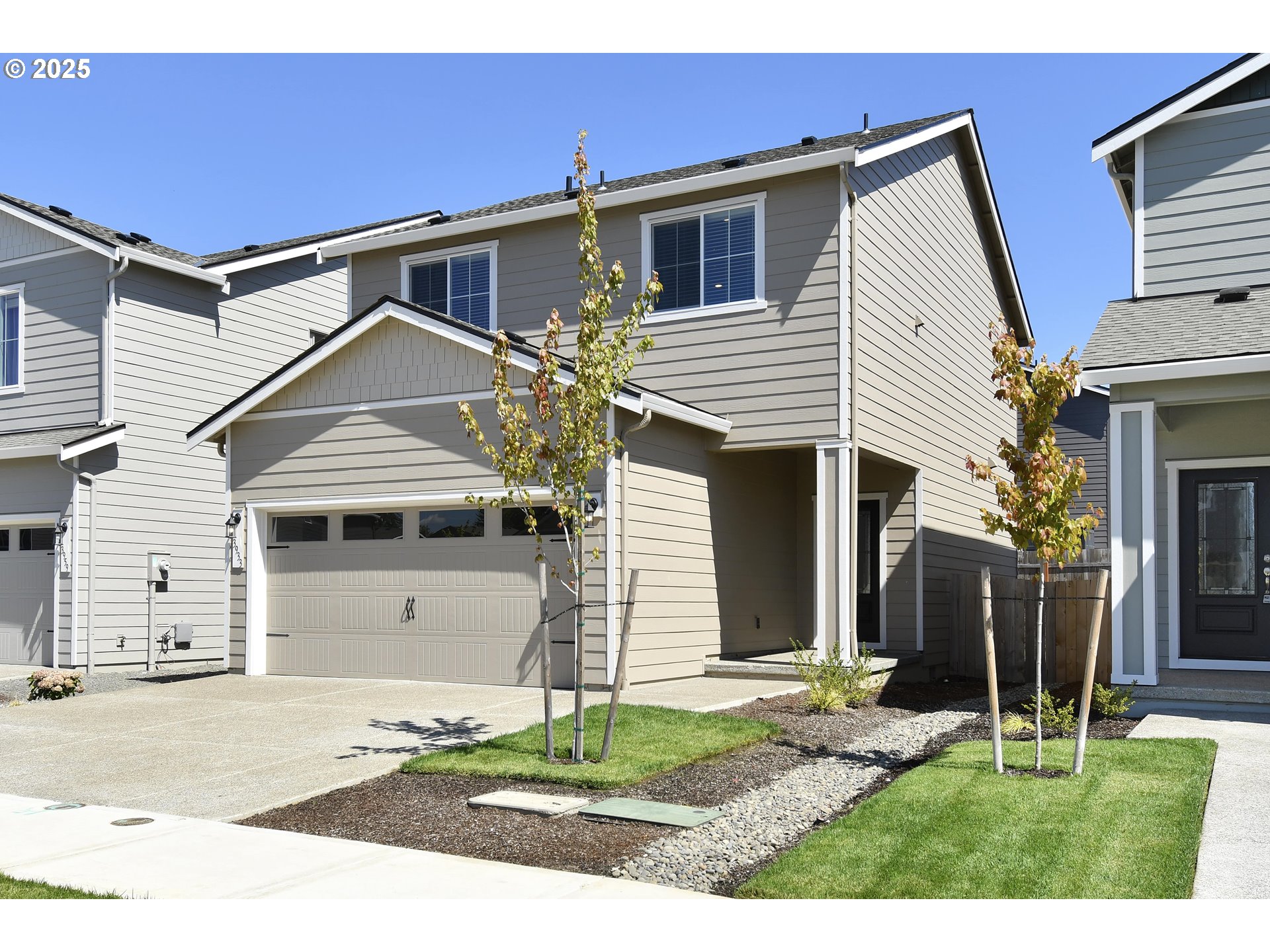 3933 Southwest Duniway Lane Gresham, OR 97080 - Photo 2 of 24 a front view of a house with a yard and garage