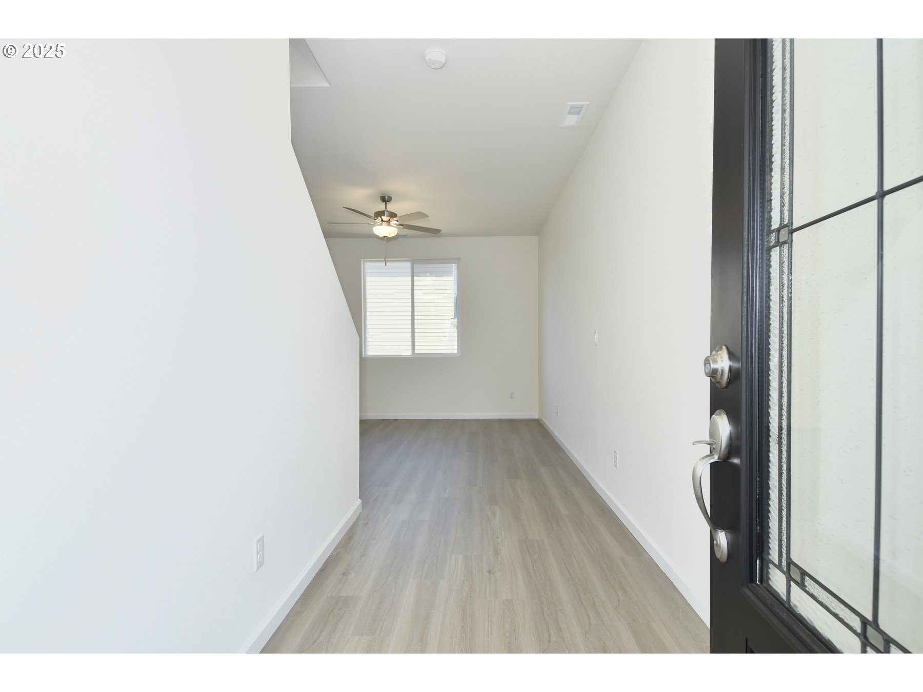 3933 Southwest Duniway Lane Gresham, OR 97080 - Photo 9 of 24 a view of an empty room with wooden floor and a window