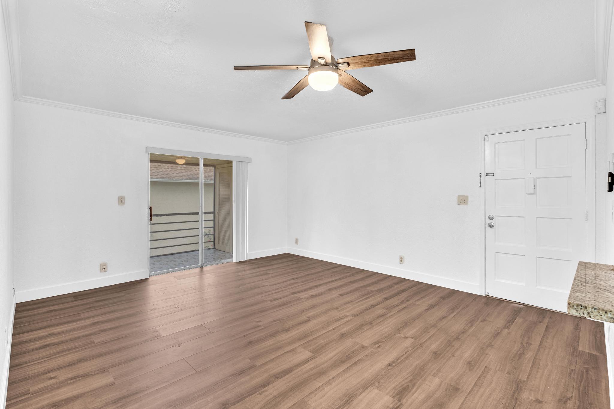 1291 Northwest 13th Street, Unit 445D Boca Raton, FL 33486 - Photo 10 of 50 an empty room with wooden floor closet and windows