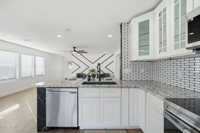 a bedroom with a bed and a ceiling fan
