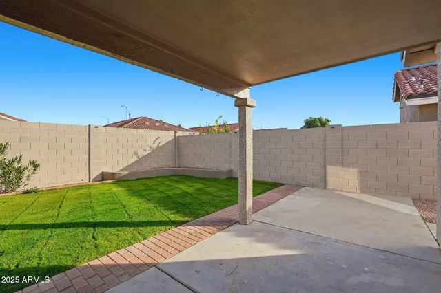 a backyard of a house with dishwasher and wooden fence