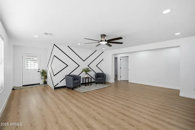 a view of a livingroom with furniture and a ceiling fan