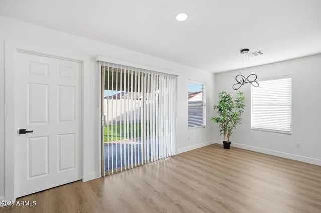 a kitchen with stainless steel appliances a white refrigerator a stove a sink and a potted plant