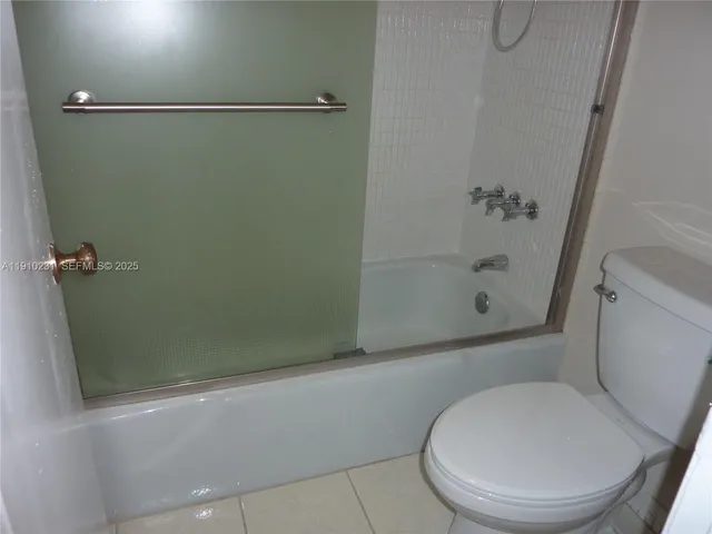 a bathroom with a granite countertop sink and washing machine