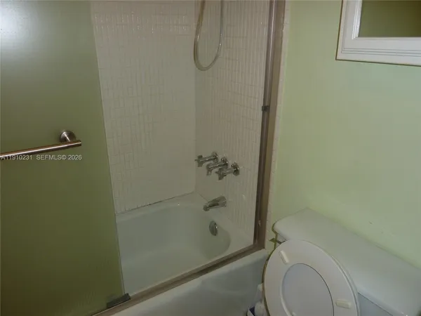 a bathroom with a granite countertop sink and washing machine