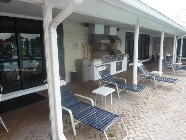a dining table with chairs and kitchen view