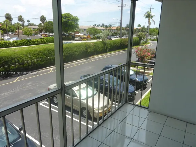 a view of a balcony with yard