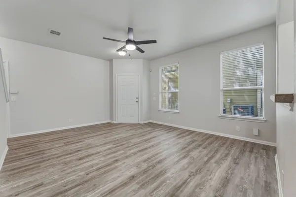 wooden floor in an empty room with a window