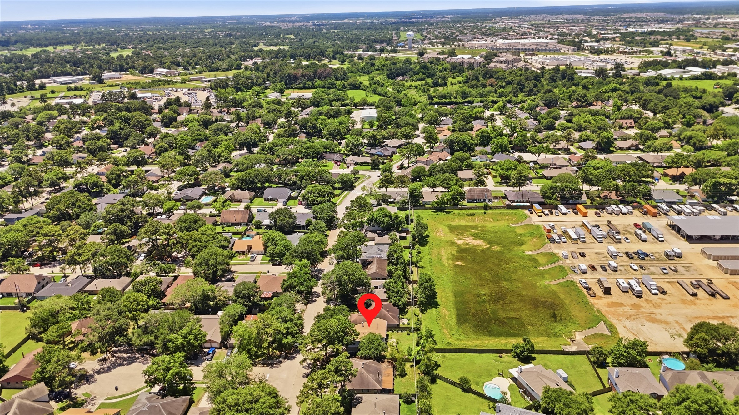 4718 Temple Bell Drive Spring, TX 77388 - Photo 50 of 50 This aerial photo showcases a suburban neighborhood with tree-lined streets and a mix of residential homes. The highlighted property is centrally located, surrounded by greenery, and offers convenient access to nearby amenities.
