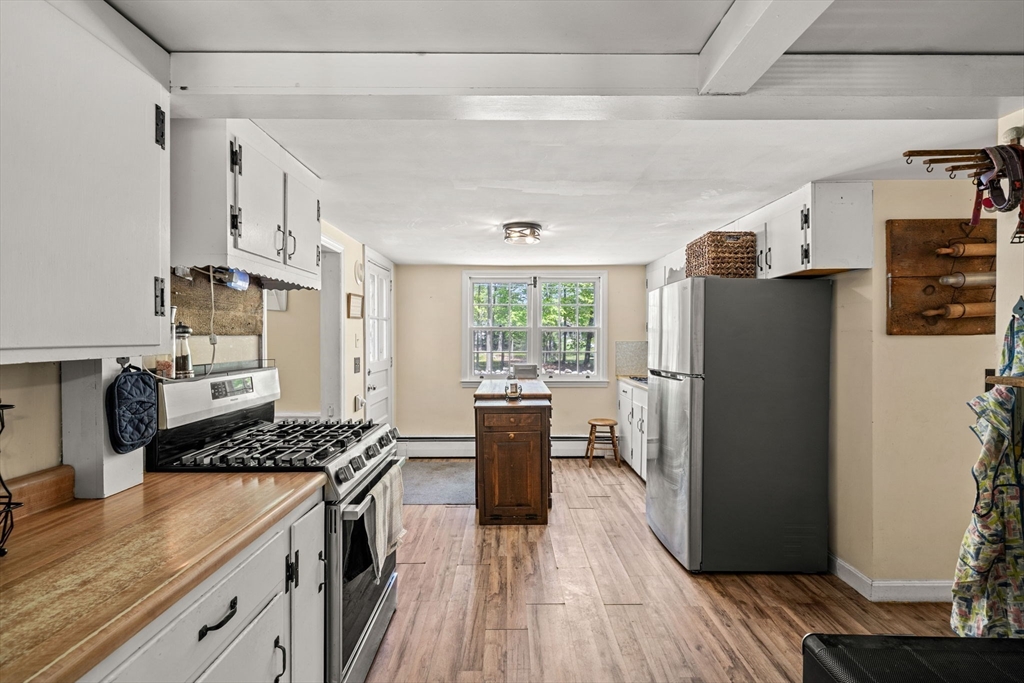 600 Main Street Ashby, MA 01431 - Photo 5 of 40 a kitchen with stainless steel appliances granite countertop a refrigerator stove and wooden floor