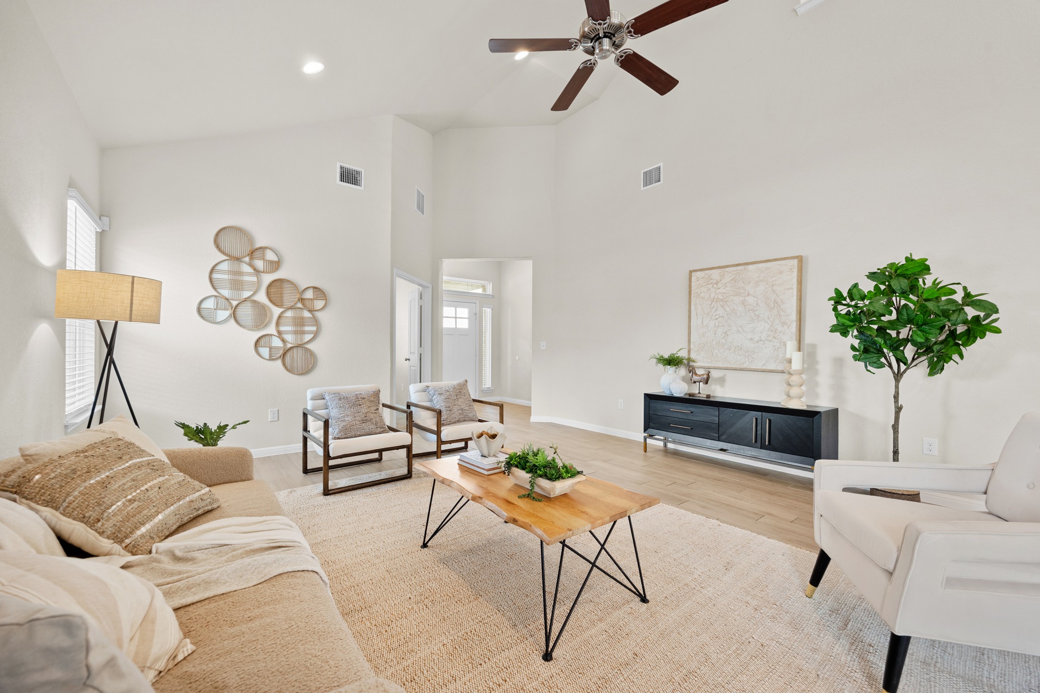 2413 Starhill Ranch Street Georgetown, TX 78628 - Photo 9 of 40 a living room with furniture a table and a potted plant