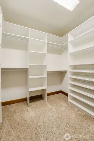 a view of an empty room with cabinet and a window