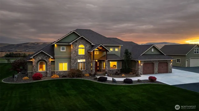 a front view of a house with a garden and plants