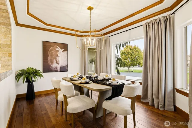 a dining room with furniture potted plants and wooden floor