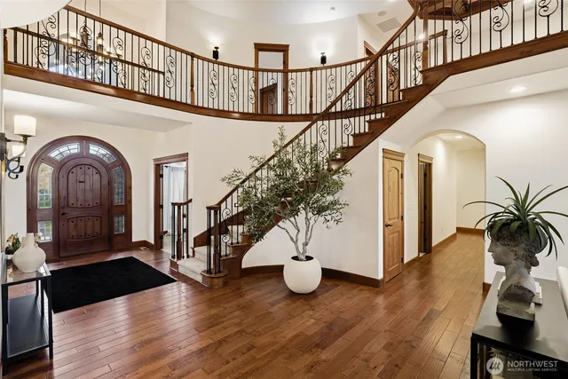 a view of entryway and hall with wooden floor